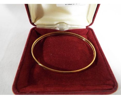 A lady's hallmarked 9ct yellow gold bangle, boxed, approximate weight 3.95 grams