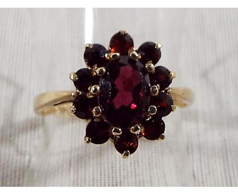 A lady's hallmarked 9ct yellow gold garnet cluster ring, approx weight 2.27grams (all in) size L and a half Est £20 - £40