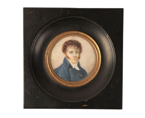 A REGENCY PORTRAIT MINIATURE OF A YOUNG MAN painted on ivory, indistinctly signed lower right, dressed in a blue doublet, 5.5