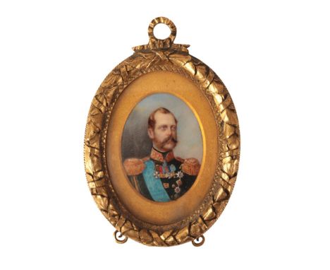 A 19TH CENTURY PORTRAIT MINIATURE painted on ivory, the gold coloured metal frame engraved to the reverse 'From His Imperial 