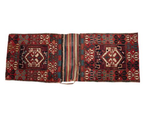 AN ANTIQUE BAKHTIARI SADDLE BAG woven to each side with central double arrow medallion on a dark blue ground, within scrolled