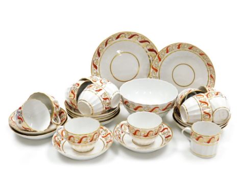An early 19thC porcelain part tea service, of fluted form decorated in iron red and gilt with scrolling leaves, comprising br