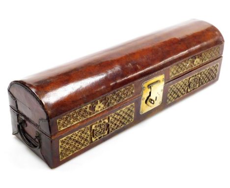 A Chinese leather domed casket, with bas-relief gilt carved decoration and brass lock plate, 52cm wide, containing a Chinese 