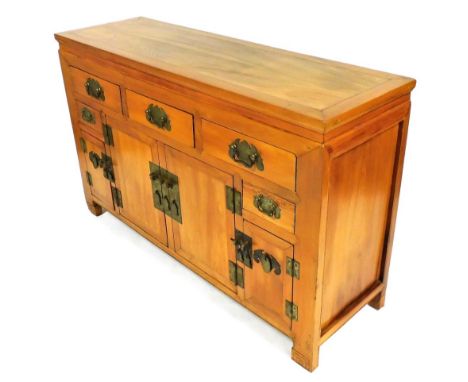 A Chinese elm altar cabinet or sideboard, with three drawers above two cupboards, flanked by a pair of small shallow drawers,