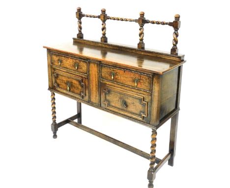 A 1920's oak sideboard, with a bobbin turned raised back, above two drawers and two panelled doors, on barley twist legs unit