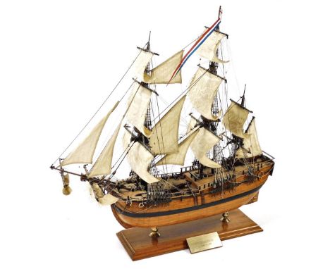 A wooden scale model of the Endeavour, a three masted sailing vessel, raised on a wooden stand with plinth, model number 140,