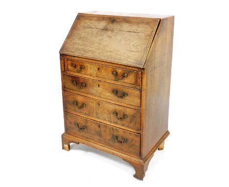 A George III mahogany bureau, the fall flap opening to reveal an arrangement of six recesses, four short and two long drawers