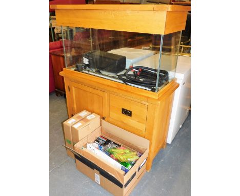 A light oak Perspex aquarium cabinet, the aquarium with a hinged lidded top, over a base with a single cupboard door and two 