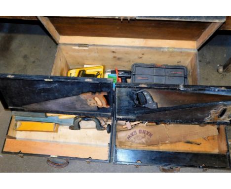 A black stained pine tool chest, containing assorted electrical and other carpentry tools, 44cm high, 101cm wide, 36cm deep, 