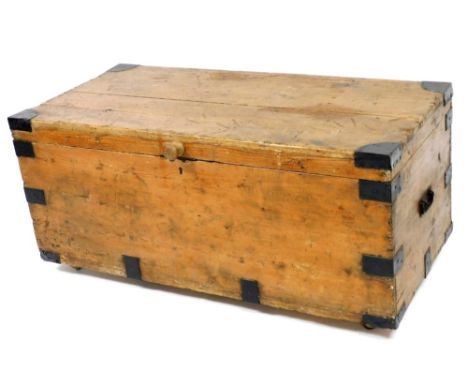 A Victorian pine and metal bound trunk, with later turned wooden handle, 54cm high, 119cm wide, 56cm deep. 