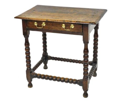 A 18thC oak side table, with a single frieze drawer, raised on bobbin turned legs united by a bobbin turned box stretcher, 72