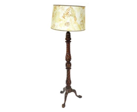 A Victorian mahogany standard lamp, of turned and spiral fluted form, raised on shell carved cabriole legs and ball and claw 