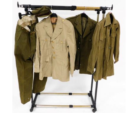 A World War II British Army Royal Corps army Ordinance officer's dress jacket, a pair of trousers, cap, shirt, and a khaki dr