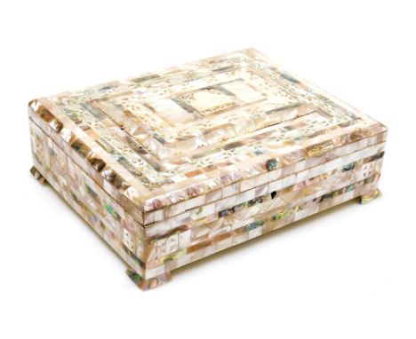 A 19thC Anglo Indian mother of pearl inlaid box, decorated to the lid with a temple and bands of scrolling leaves, raised on 
