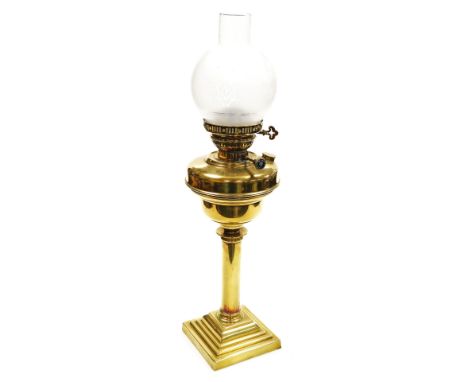 A Veritas brass oil lamp, with a clear and etched chimney shade, 63cm high. 