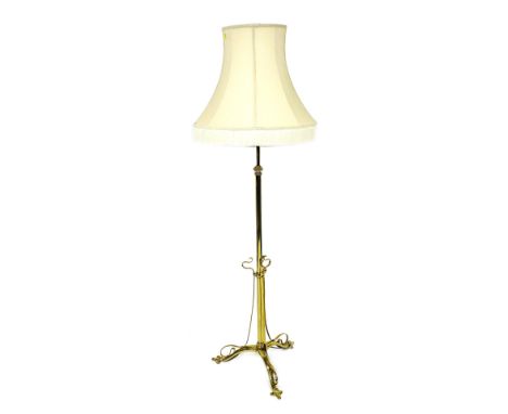 A Victorian Arts and Crafts brass standard lamp, with shade, 175cm high. 
