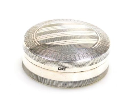 A George V silver pill box, of circular form, the lid with engine turned decoration, Stokes and Ireland Ltd, Chester 1920, 5.