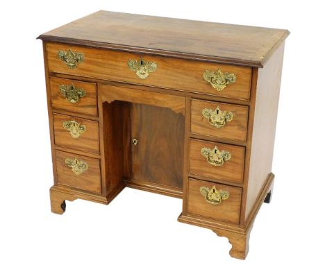 A Georgian mahogany kneehole desk, with one long frieze drawer, over a recess with semi secret drawer and cupboard below, fla
