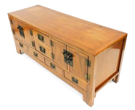 A Chinese elm sideboard, the top with two short drawers flanked by two cupboards, the base with four short drawers, with rect