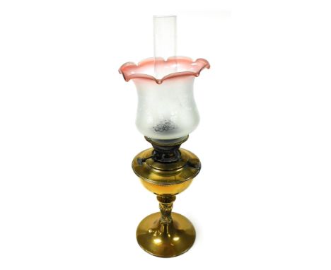 A Veritas late 19thC brass oil lamp, with a glass chimney and etched frosted glass shade, with a cranberry frilled rim, 61cm 