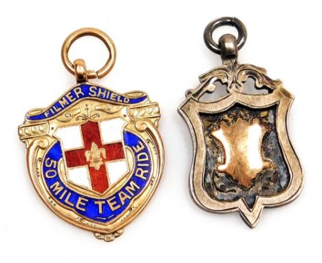 A 9ct gold and enamel shield pendant ''Film Shield 50 Mile Team Ride'', 6.2g, together with a Dunholme and Welton United Foot