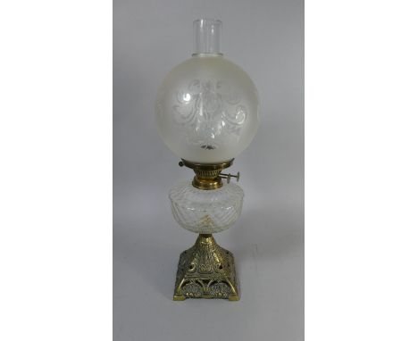 A Victorian Brass Based Oil Lamp with Glass Reservoir, Etched Globe and Plain Chimney 