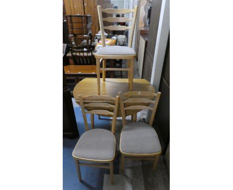 A Drop Leaf Kitchen Table and Three Ladder Back Chairs 