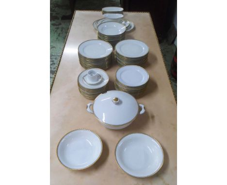 BAVARIAN CERAMIC DINNER SERVICE, white with gold rim, including twenty four dinner plates (damage to stand of sauce boat). (7