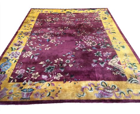 NICHOLS ART DECO CHINESE CARPET, 345cm x 274cm, floral field within an imperial yellow matching border.