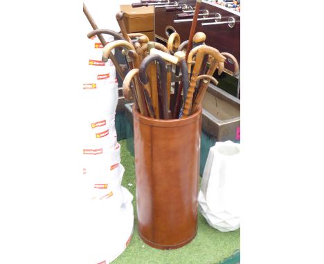 STICK STAND, L&L label to base, circular in tanned leather, plus a large quantity of walking sticks some with silver mounts, 