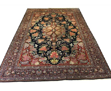 FINE ANTIQUE KASHAN CARPET, 310cm x 218cm, circa 1930, floral medallion on a sapphire field surrounded by bouquets and flower