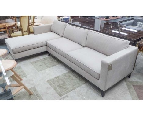 CORNER SOFA, in cream fabric with wooden plinth on square supports, 296cm x 175cm.