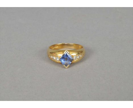 An 18ct gold sapphire and diamond ring, designed as a central rhombus shaped sapphire flanked to each side with graduated bri