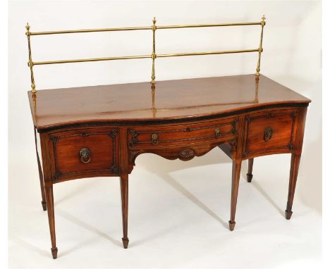 A 19th century mahogany serpentine sideboard, the shaped plumb pudding top with a polished brass railed gallery overhanging a
