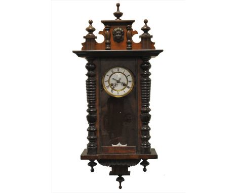 A walnut cased Vienna wall clock, with a white enamelled dial populated with black Roman numerals and 8-day spring-driven mov