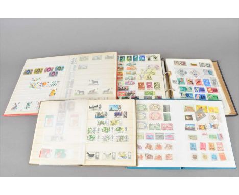 A collection of six stamp albums and stock books, together with a collection of loose stamps