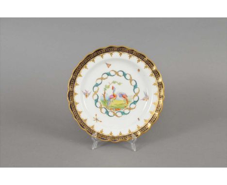 A Royal Worcester plate dated 1884 of scalloped form, painted with fancy birds within gold and green wreath, scattered insect