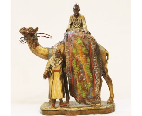 Austrian cold painted spelter table lighter in the form of an Arab carpet seller with camel and servant, 20cm high. Lacking s