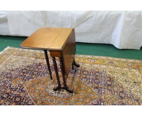 Mahogany Sutherland table, ring turned supports on bracket feet and ceramic castors, 67cm high x 60cm long.