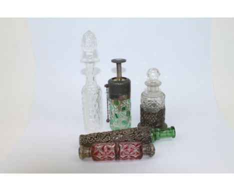 Five dressing table bottles including double ended red and clear cut glass scent bottle, green and clear hobnail design cut g