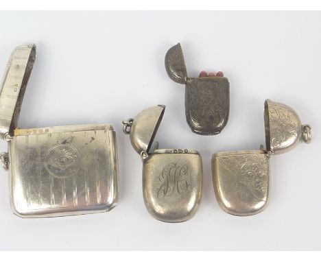 Three silver vesta cases of ovoid form and another with striped engine turning. (4)