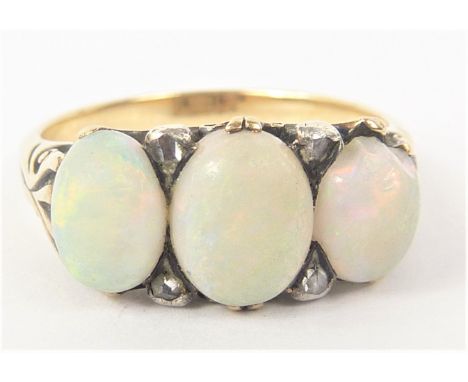 Victorian opal three stone ring with diamond points in gold.