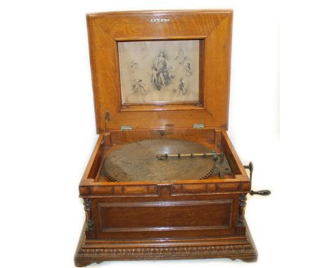 Late 19th century "Regina" Polyphon disc playing oak music box.  The lid with bobbin turned open gallery under hood hangs ove