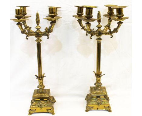 Pair of brass four sconce candelabra, the foliate branches on reeded column with pine cone finial and square stepped plinth b