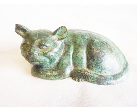 Cast bronze figure of a recumbent cat with verdigris patina, hollow base, 15cm long.