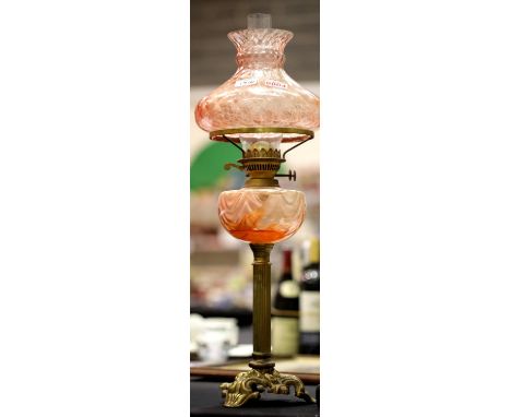 Victorian brass based paraffin lamp with glass reservoir and shade H(to top of shade) 67 cm. This lot is not available for in