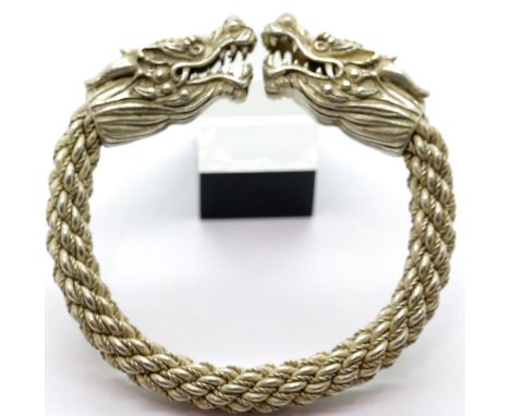 White metal Tibetan silver large dragon bangle, D: 9 cm. P&amp;P Group 1 (£14+VAT for the first lot and £1+VAT for subsequent