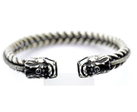 White metal Tibetan silver woven dragon bangle, D: 7 cm. P&amp;P Group 1 (£14+VAT for the first lot and £1+VAT for subsequent