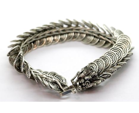 White metal Tibetan silver linked dragon bracelet, L: 20 cm. P&amp;P Group 1 (£14+VAT for the first lot and £1+VAT for subseq