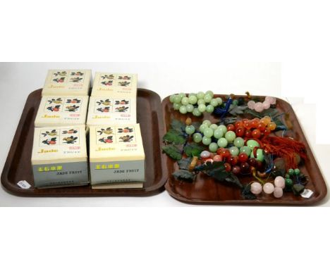 A quantity of Chinese hard stone carved fruit and grapes, some boxed titled 'Jade fruits' (two trays)